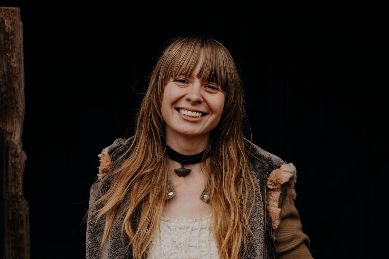 Jennifer smiling in the opening of one of her historical horse stables. Photo by Grace Jones.